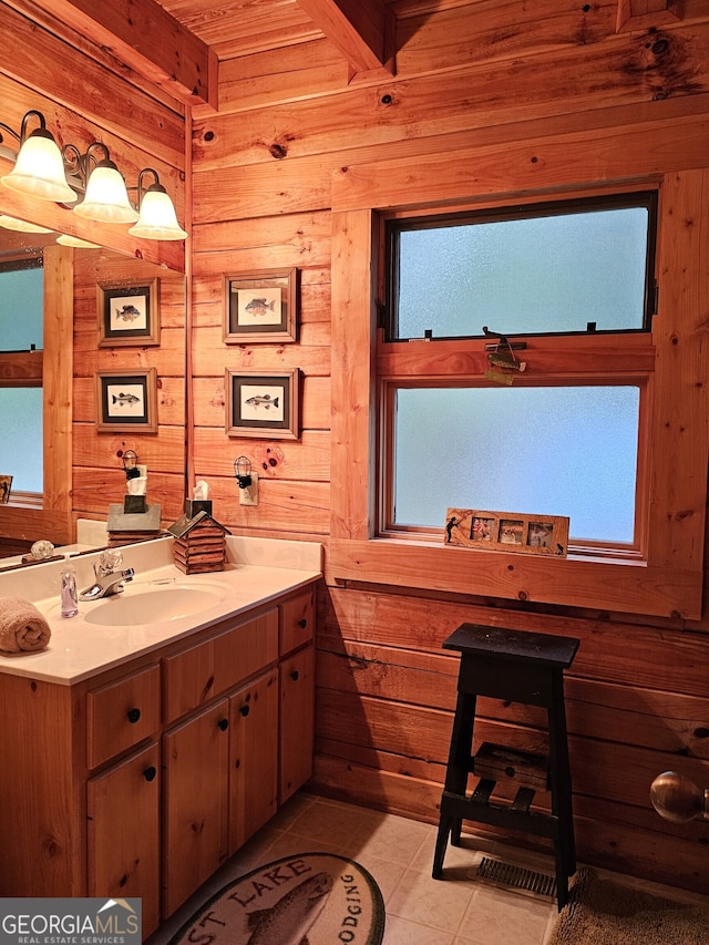 bathroom featuring wood walls, vanity, and tile patterned floors