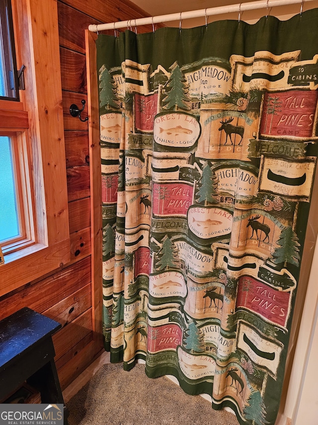 bathroom with wood walls