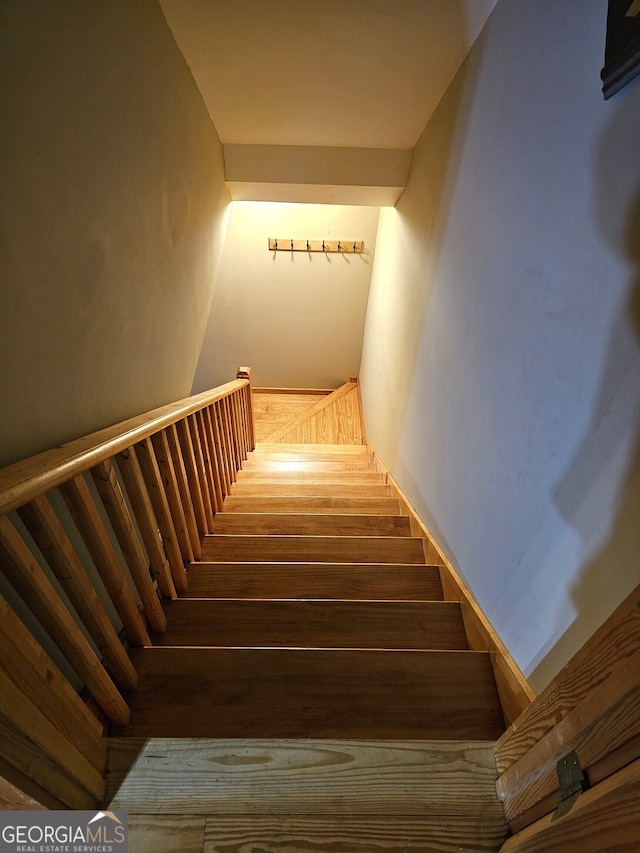 staircase featuring wood-type flooring