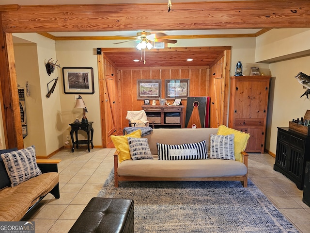 tiled living room with wooden walls and ceiling fan