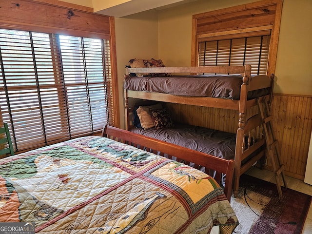 bedroom with wooden walls