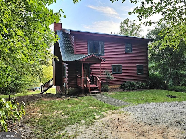 rear view of property with a yard