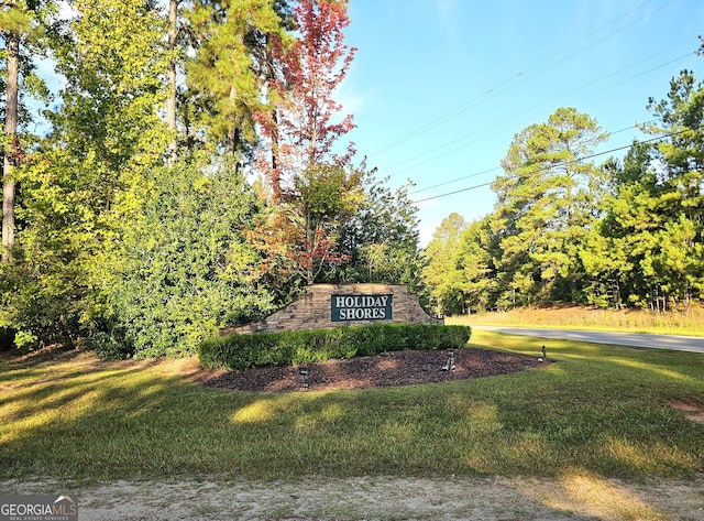 community sign featuring a lawn