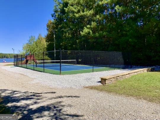 exterior space featuring a playground and tennis court