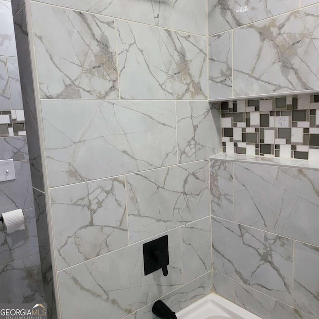 bathroom with tiled shower