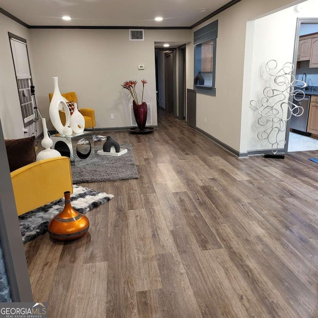 interior space featuring ornamental molding and hardwood / wood-style floors