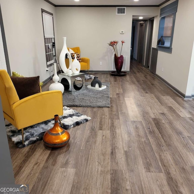 living area featuring ornamental molding and hardwood / wood-style floors