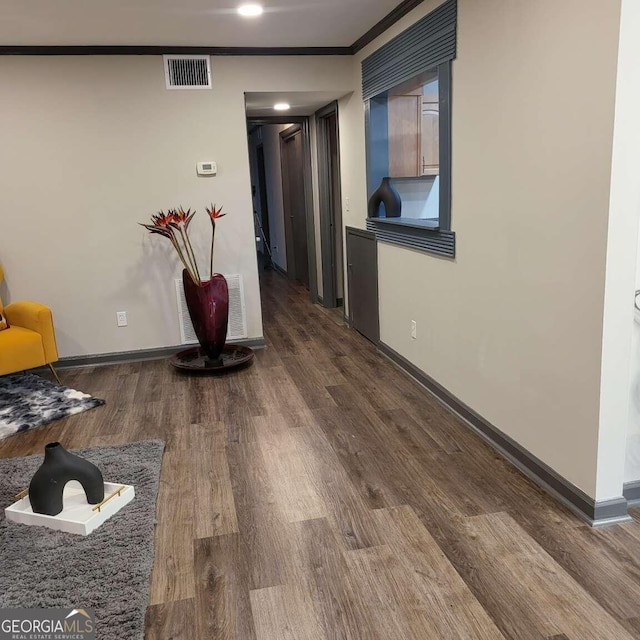 hall featuring ornamental molding and hardwood / wood-style flooring