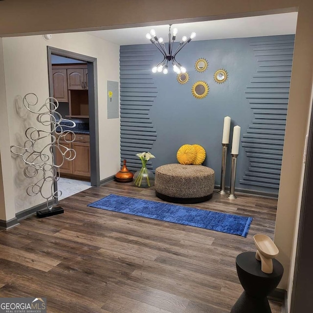 living area with a chandelier and dark hardwood / wood-style flooring