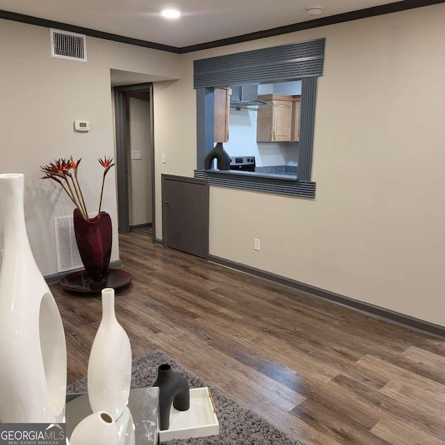 interior space featuring hardwood / wood-style flooring and ornamental molding