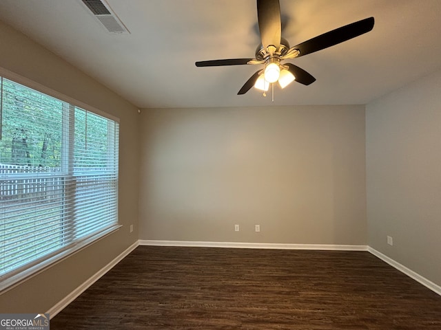 unfurnished room featuring ceiling fan and dark wood-type flooring