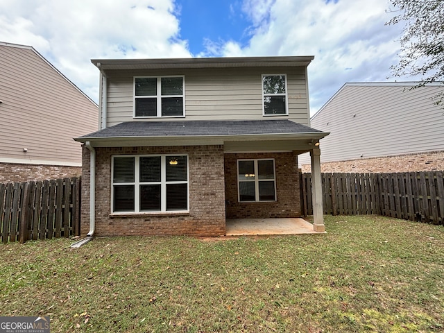 rear view of house with a patio area and a yard