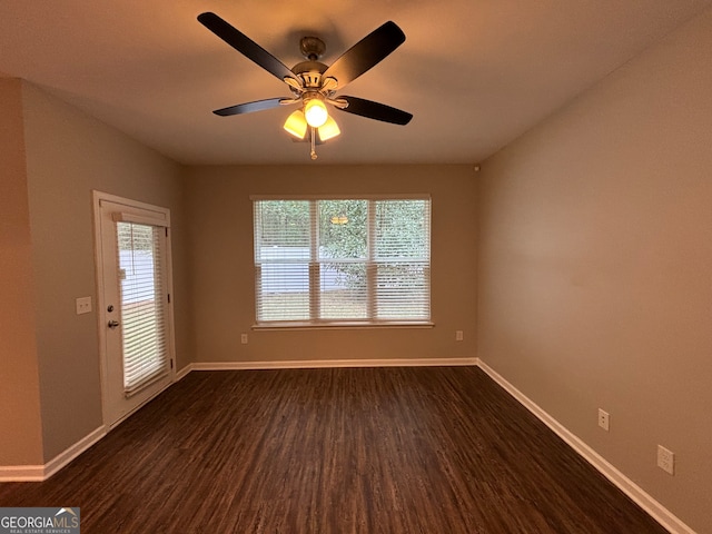 unfurnished room featuring ceiling fan and dark hardwood / wood-style floors