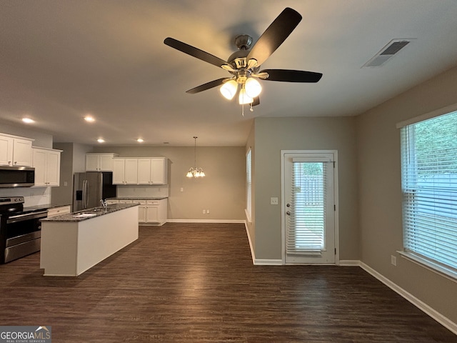 kitchen featuring a center island with sink, white cabinetry, dark wood-type flooring, and stainless steel appliances