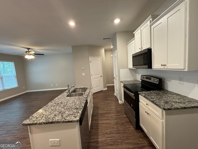 kitchen with white cabinets, sink, a kitchen island with sink, appliances with stainless steel finishes, and dark hardwood / wood-style flooring