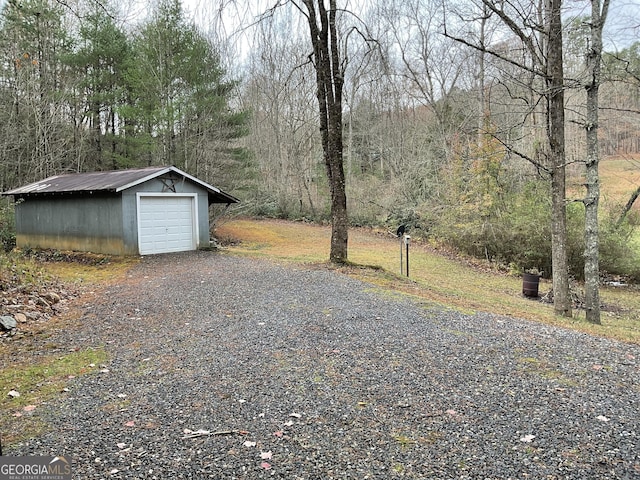 exterior space featuring a garage and an outdoor structure