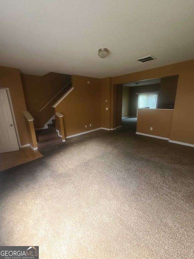 unfurnished living room featuring carpet