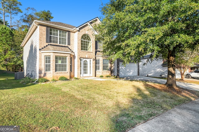 view of front of house with a garage, a front lawn, and central air condition unit