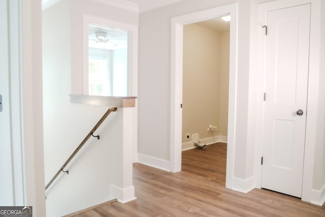 hallway with light hardwood / wood-style floors