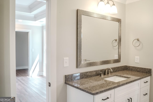 bathroom featuring hardwood / wood-style flooring, vanity, and crown molding