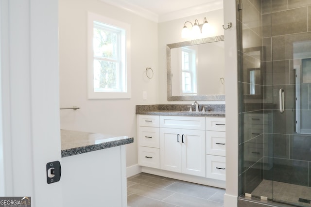 bathroom featuring crown molding, vanity, and a shower with shower door