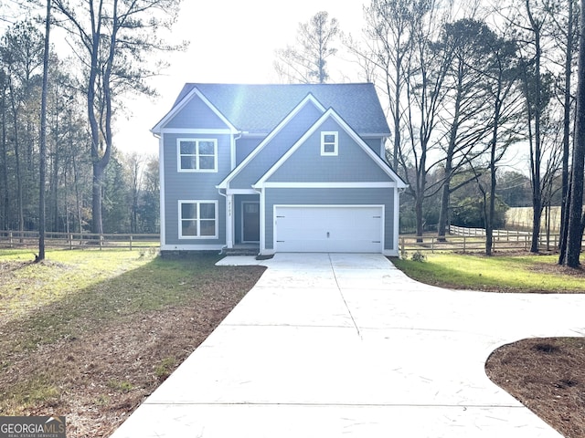 view of front of house featuring a garage and a front yard