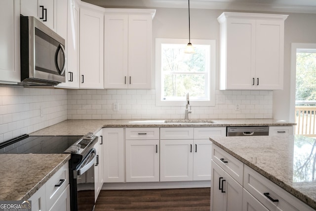 kitchen with stainless steel appliances, white cabinetry, and sink