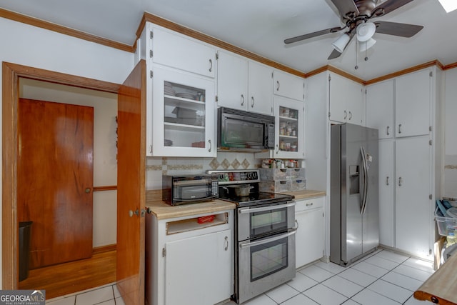 kitchen featuring light tile patterned flooring, white cabinetry, backsplash, appliances with stainless steel finishes, and ceiling fan