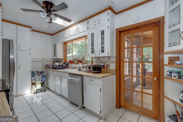 kitchen featuring white cabinetry, backsplash, appliances with stainless steel finishes, ornamental molding, and ceiling fan