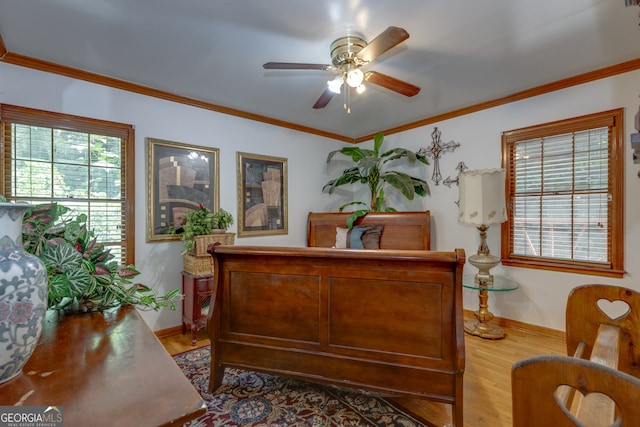 bedroom with ornamental molding, ceiling fan, and hardwood / wood-style flooring