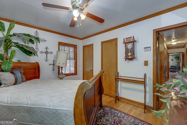 bedroom with light hardwood / wood-style floors, ornamental molding, and ceiling fan