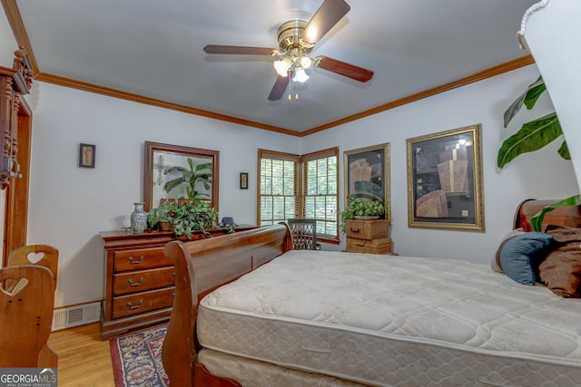 bedroom with light hardwood / wood-style flooring, ceiling fan, and ornamental molding