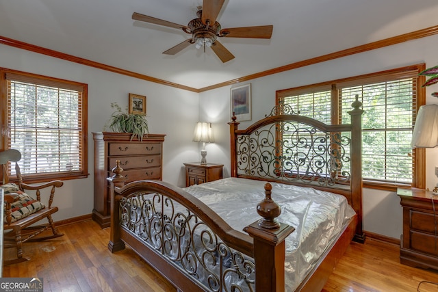 bedroom with multiple windows, hardwood / wood-style floors, and ceiling fan