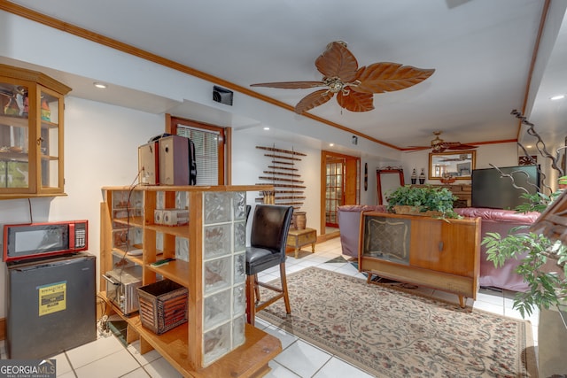 interior space with ceiling fan and crown molding