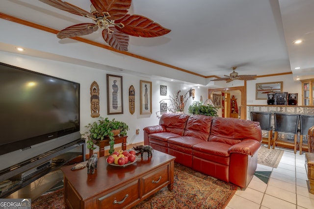 living room with ceiling fan, crown molding, and light tile patterned floors