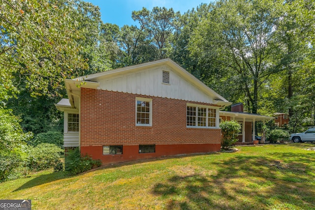 view of side of home featuring a lawn