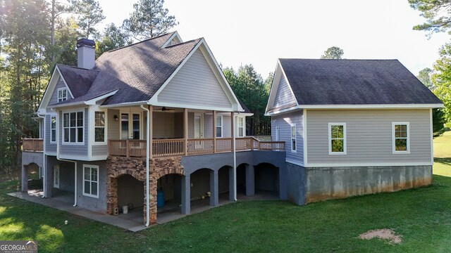 rear view of house featuring a patio area and a yard