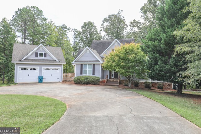 view of front of property with a front yard and a garage