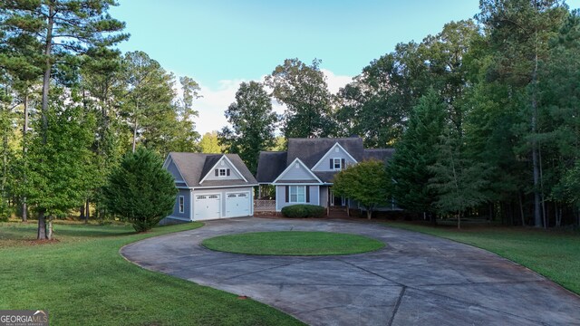 view of front of home with a front lawn and a garage