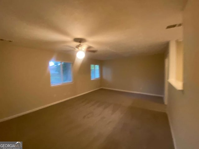 unfurnished room featuring ceiling fan and carpet flooring