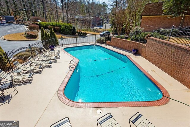 view of swimming pool featuring a patio area