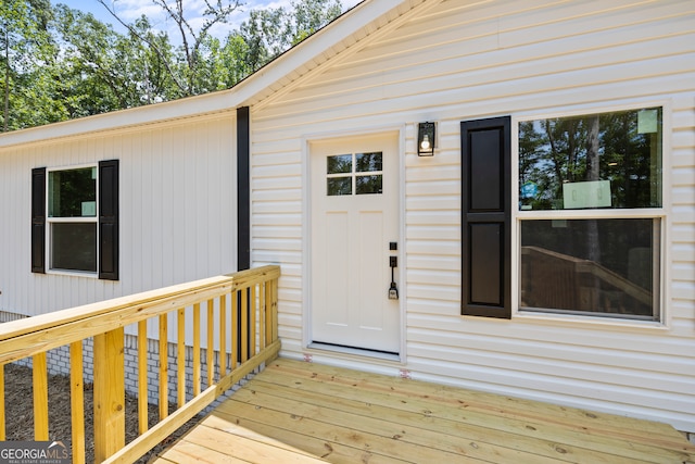 view of exterior entry with a wooden deck