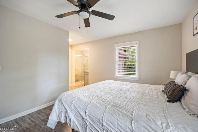 bedroom with dark wood-type flooring, ceiling fan, and ensuite bathroom