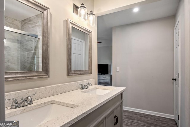 bathroom with vanity, hardwood / wood-style floors, and a shower with shower door