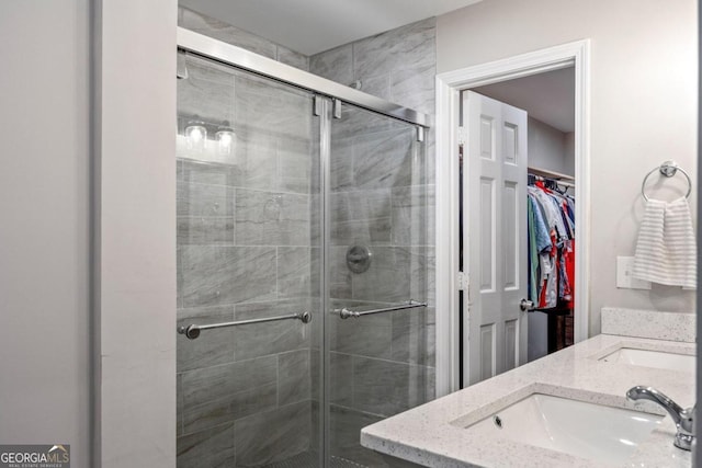 bathroom with vanity and a shower with shower door