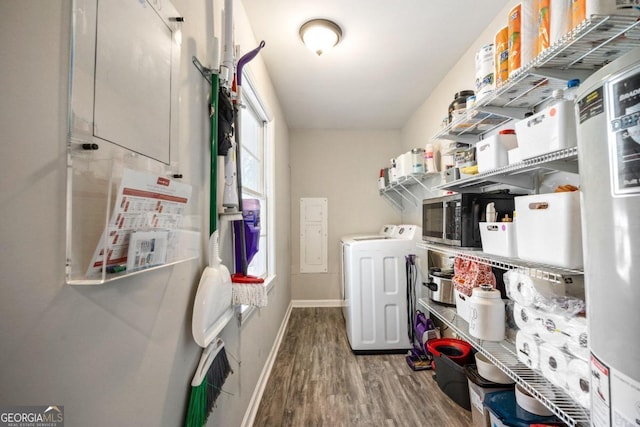 washroom with hardwood / wood-style flooring and washer and clothes dryer