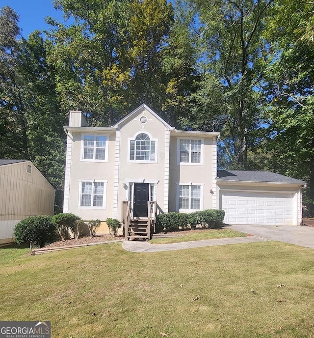 colonial inspired home featuring a garage and a front yard