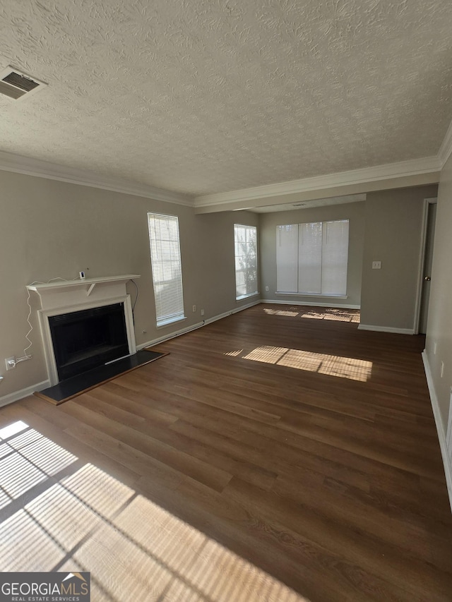 unfurnished living room with hardwood / wood-style floors, a textured ceiling, and crown molding