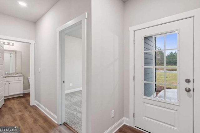 doorway to outside featuring plenty of natural light and dark hardwood / wood-style flooring