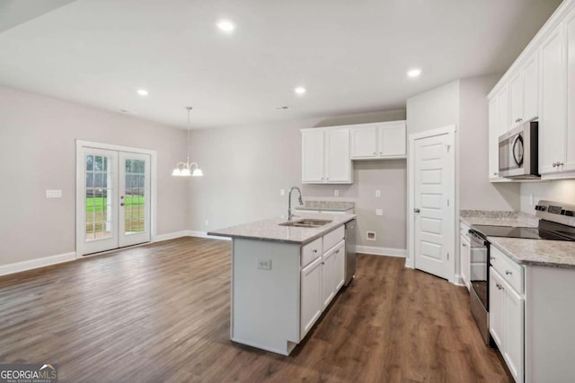 kitchen featuring an island with sink, appliances with stainless steel finishes, sink, and white cabinetry